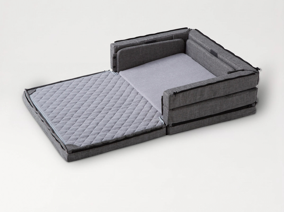 Compact Bed Free in Melange Gray in half-open mode: one half unfolded flat, the other half with its sides up