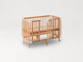 The färska Creative Cot Long as a cot: slatted base, the side gate open, on castors