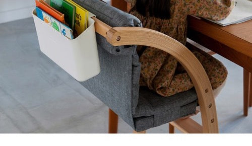 Hanging Box with picture books on the back of the Scroll Chair One