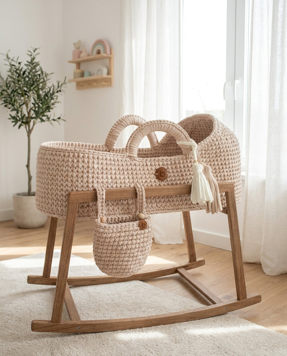 Handwoven Moses basket on a wooden rocking stand near a window