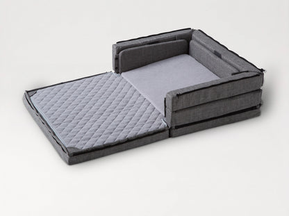 Compact Bed Free in Melange Gray in half-open mode: one half unfolded flat, the other half with its sides up 