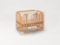 The färska Creative Cot as a cot: slatted base in the low position, the side gate open, on castors