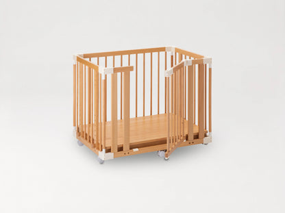 Creative Cot as a playpen with a solid floor and the side gate open