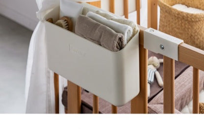 Hanging Box hooked on the Creative Cot frame with care items inside