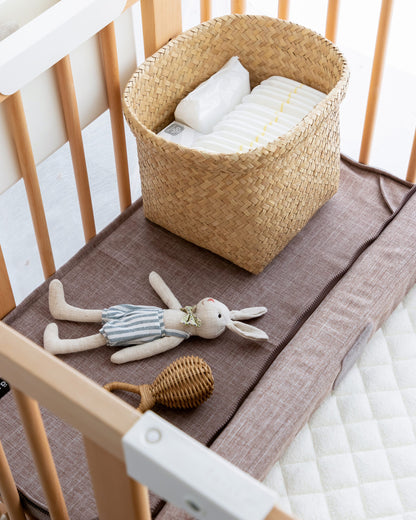 Joint Mattress 30x60 in Melange Brown used as a changing area inside the cot 