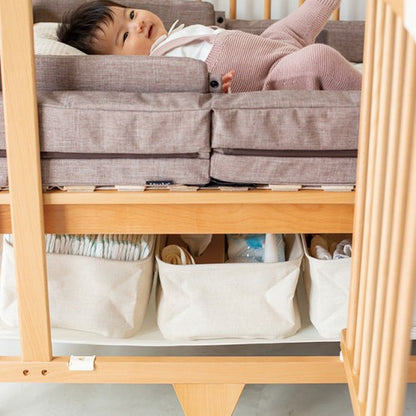 Nappies and care items stored on the lower level of the Creative Cot