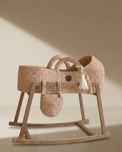 Beige handwoven Moses basket on the wooden rocking stand