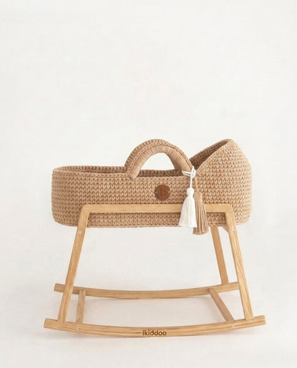 Beige handwoven Moses basket, side view on the wooden stand