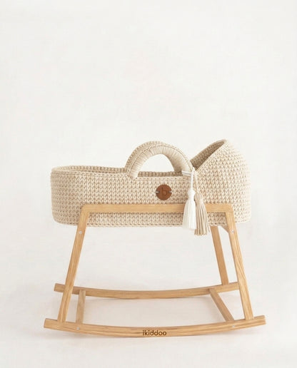 Ecru handwoven Moses basket, side view on the wooden stand