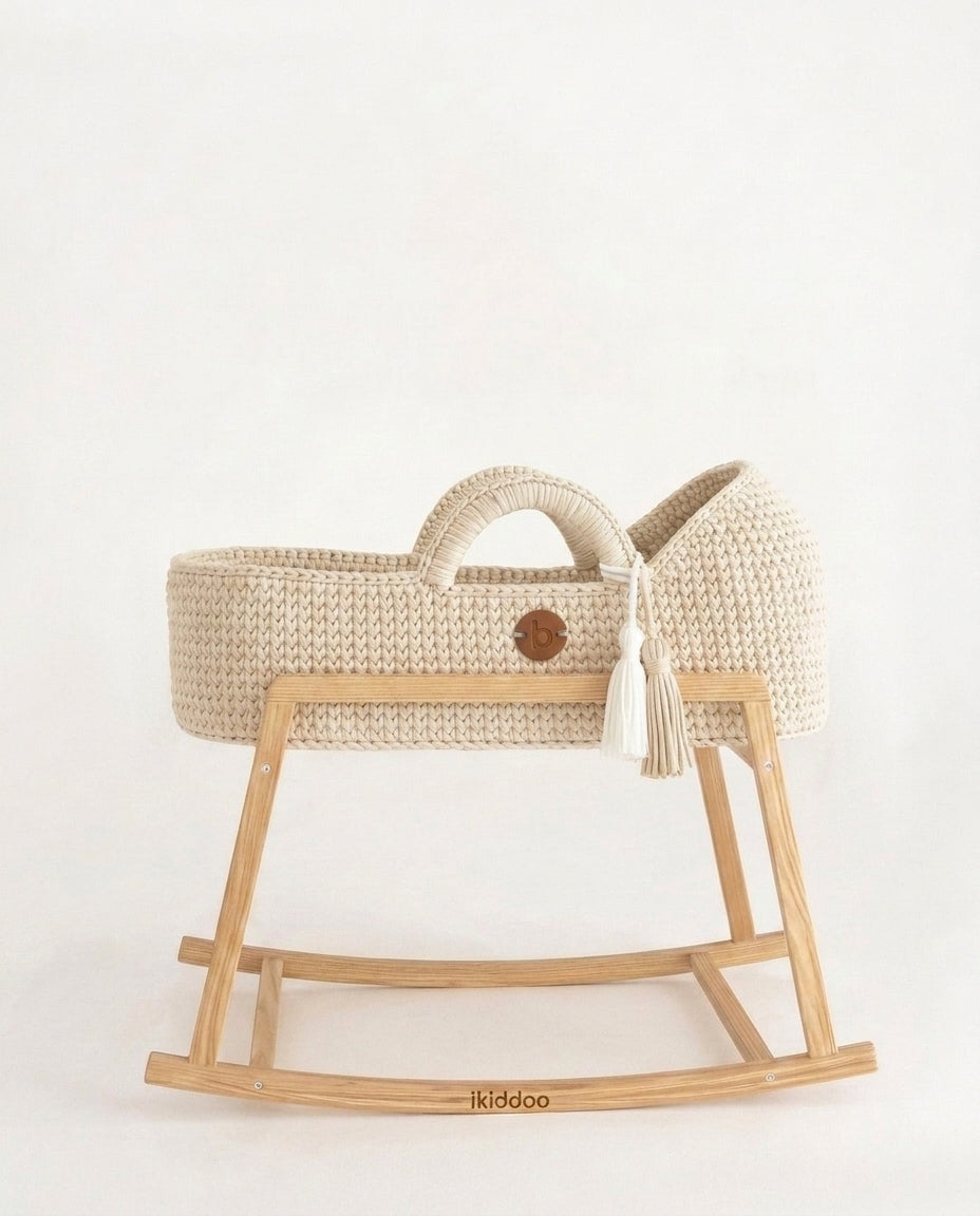 Ecru handwoven Moses basket, side view on the wooden stand