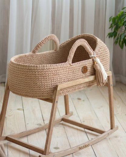 Handwoven Moses basket on the wooden rocking stand close-up