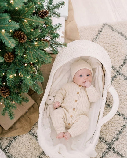 Baby resting in the handwoven Moses basket