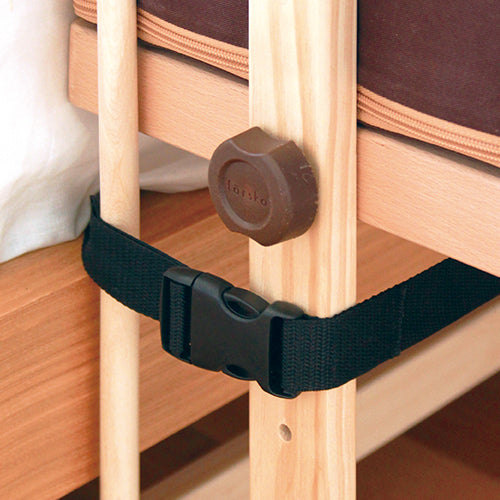 Belt buckle fastened around the cot rail