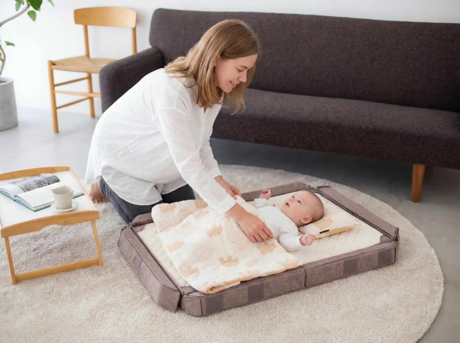 A mother caring for her baby in the open Compact Bed Free at home