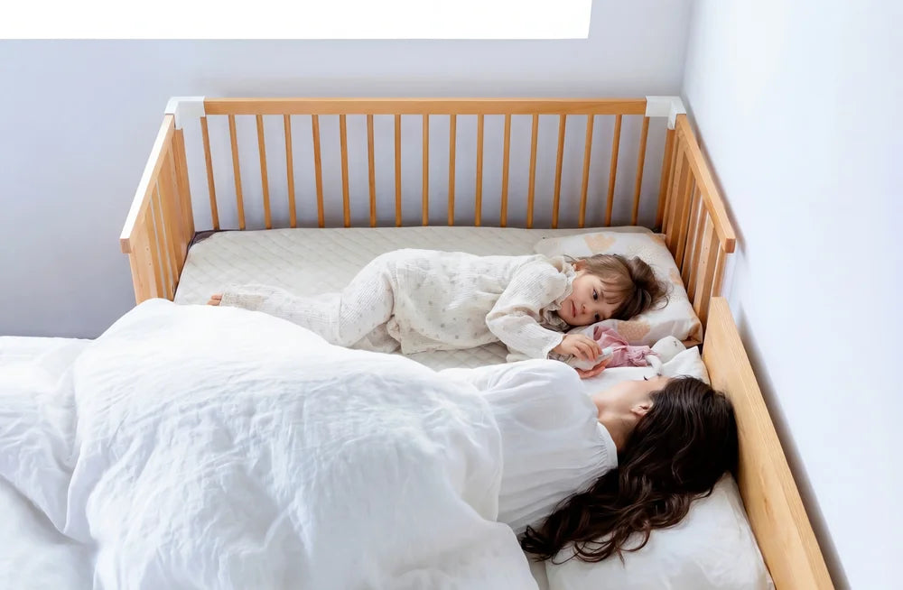 A 2-3 year old sleeping in the Creative Cot Long right next to mom's bed