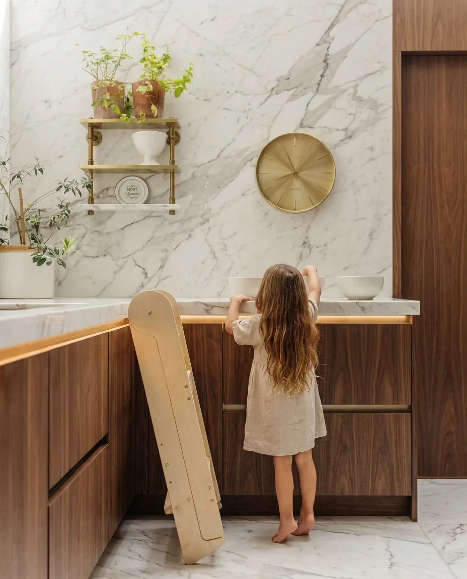 Learning tower folded flat and leaning against a kitchen cabinet