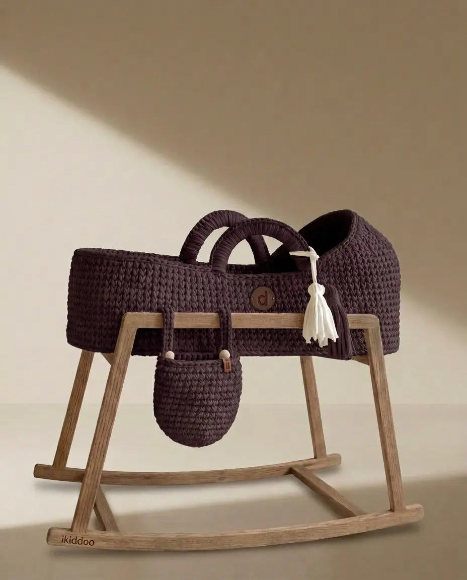 Pearl-colored handwoven basket on a dark wooden stand beside a plant