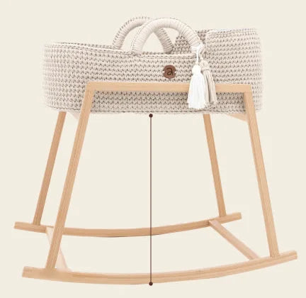Handwoven Moses basket on the high rocking stand, level with an adult bed