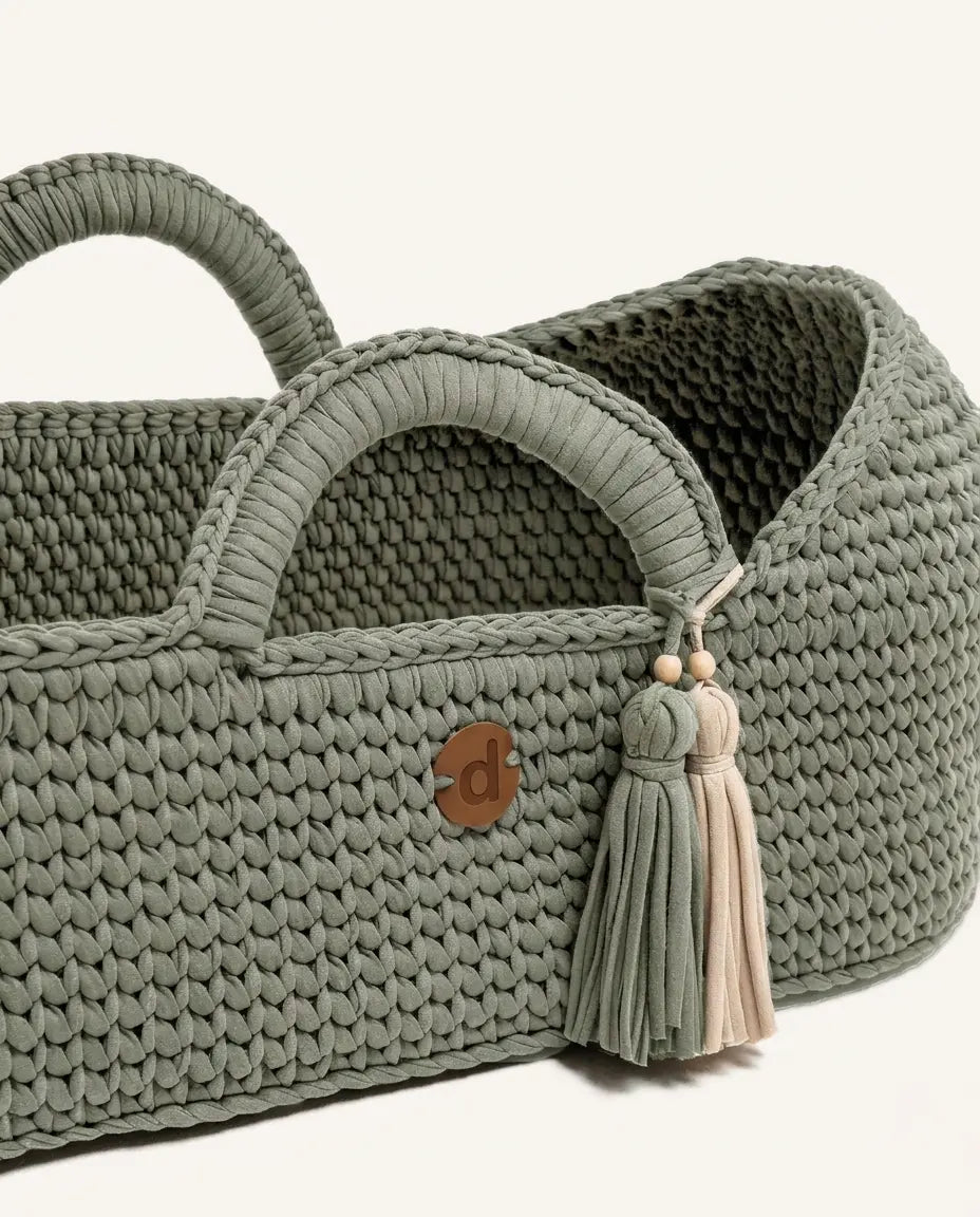 Close-up of the knitted basket wall with dense stitches, wrapped handle and tassels